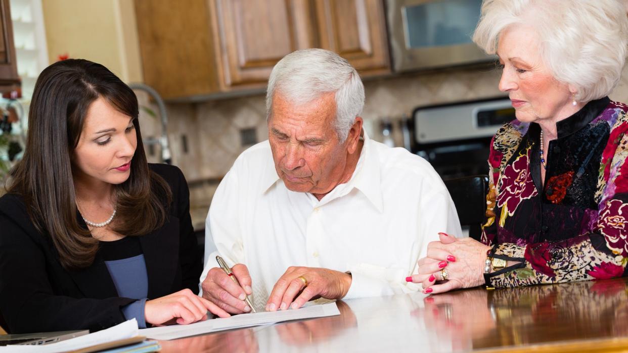 A business woman working with her senior citizen clients.