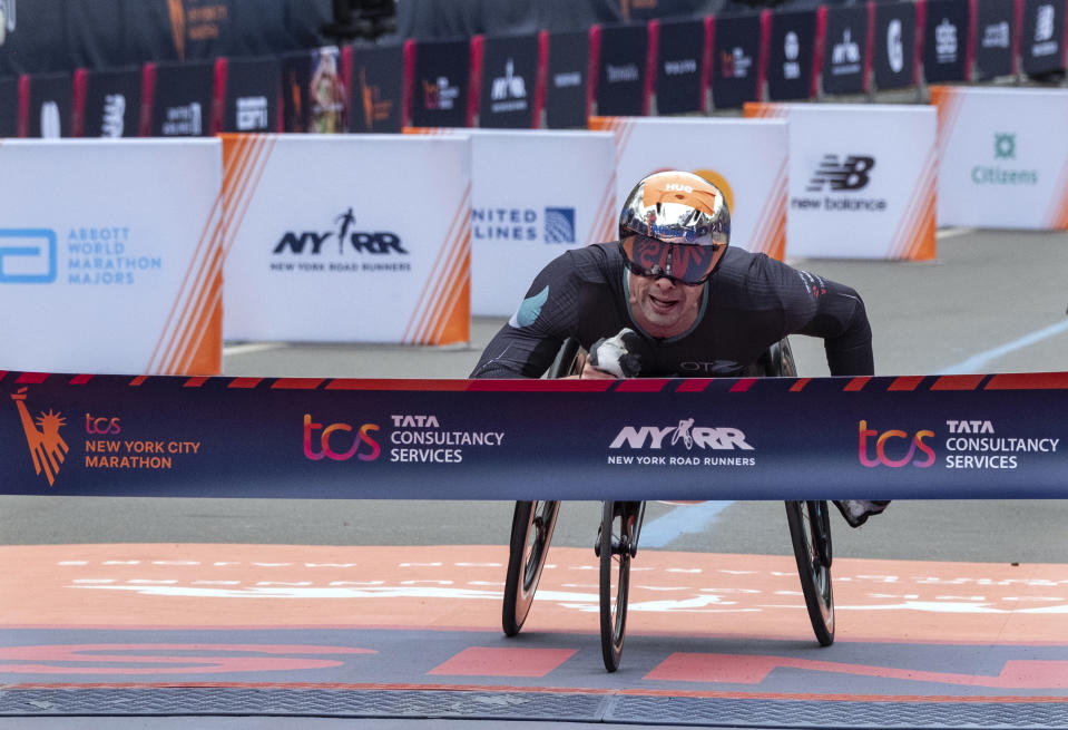 Marcel Hug of Switzerland crosses the finish line first in the men's wheelchair division of the New York City Marathon, Sunday, Nov. 5, 2023, in New York.(AP Photo/Craig Ruttle)