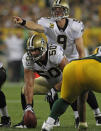 GREEN BAY, WI - SEPTEMBER 08: Olin Kreutz #50 of the New Orleans Saints prepares to snap the ball as Drew Brees #9 calls out the defense against the Green Bay Packers during the NFL opening season game at Lambeau Field on September 8, 2011 in Green Bay, Wisconsin. (Photo by Jonathan Daniel/Getty Images)