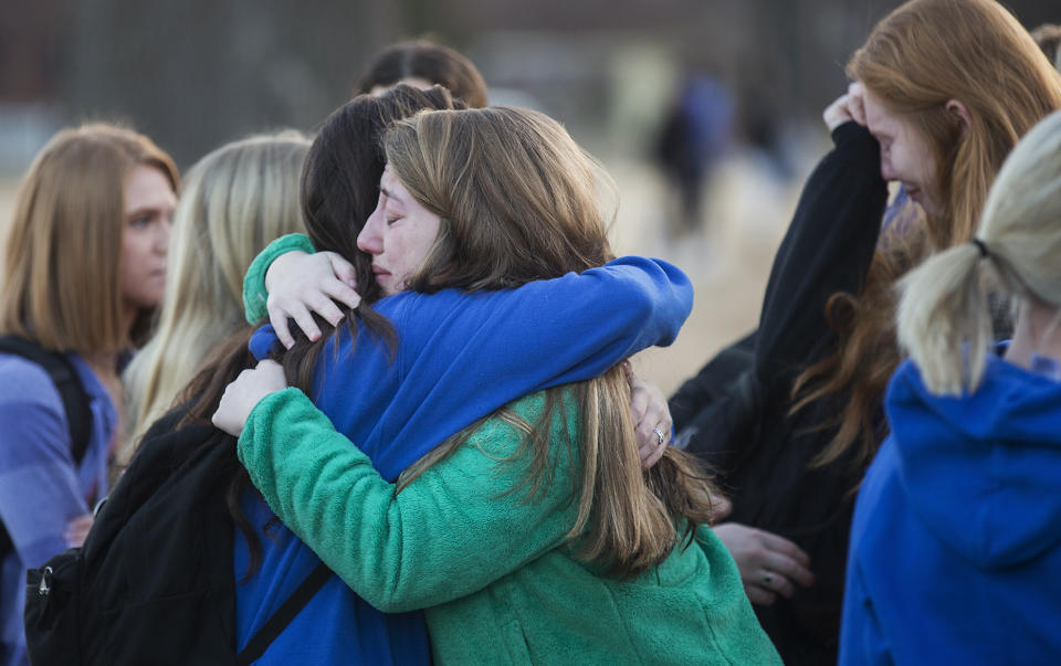 Students embrace after a prayer vigil in Paducah, Ky., on Wednesday, in honor of the victims of the Marshall County High School shooting the day before. (Ryan Hermens/The Paducah Sun via AP)
