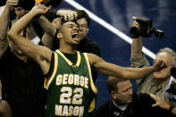 FILE - In this Monday, March 26, 2006, file photo, George Mason's Lamar Butler (22) reacts after beating Connecticut 86-84 in overtime during the fourth round game of the NCAA basketball tournament in Washington. (AP Photo/Susan Walsh, File)