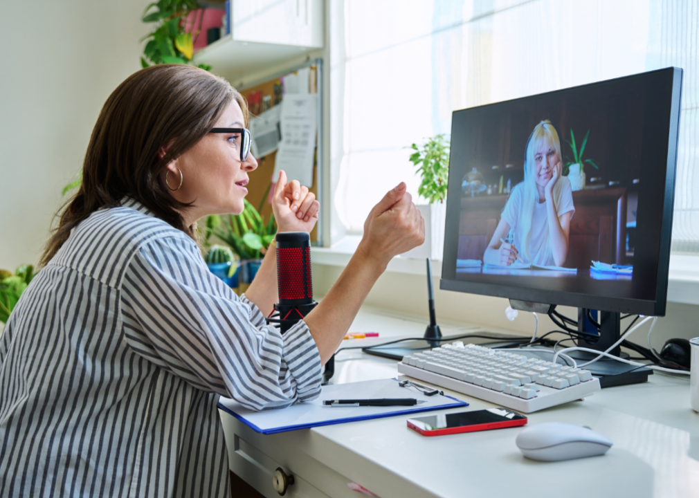 Woman sitting in front of a computer for a virtual meeting with a therapist.