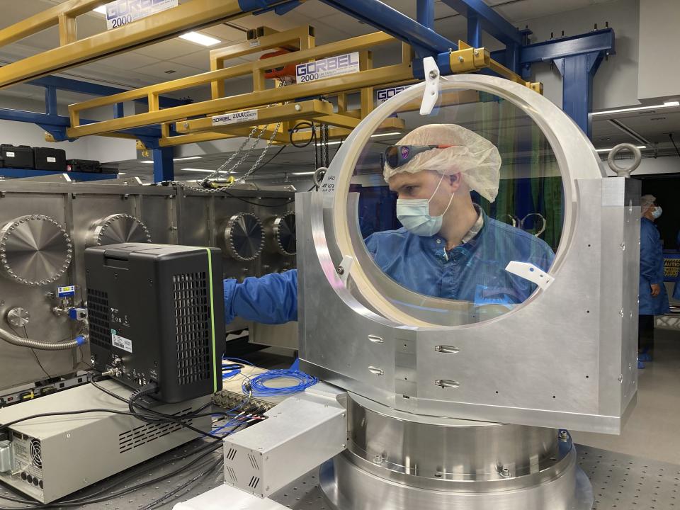 University of Michigan research scientist Andrew McKelvey inspects a prototype vacuum compatible mirror mount inside the ZEUS laser facility on Friday, Sept. 2, 2022, in Ann Arbor, Mich. The newly constructed facility will be home to the most powerful laser in the U.S. (AP Photo/Mike Householder)