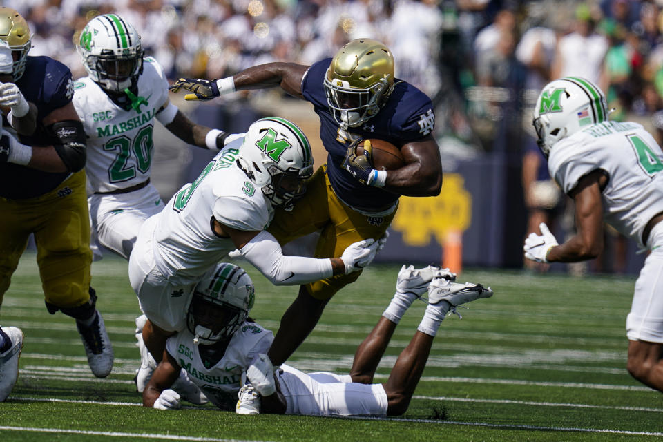 Notre Dame running back Audric Estime is tackled by Marshall defensive back Steven Gilmore during the first half of an NCAA college football game in South Bend, Ind., Saturday, Sept. 10, 2022. (AP Photo/Michael Conroy)
