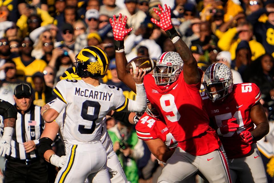 Ohio State's Zach Harrison pursues Michigan quarterback J.J. McCarthy during their game in 2022. Harrison, an Olentangy Orange graduate, now plays for the Atlanta Falcons and McCarthy was a first-round pick this year by Minnesota.