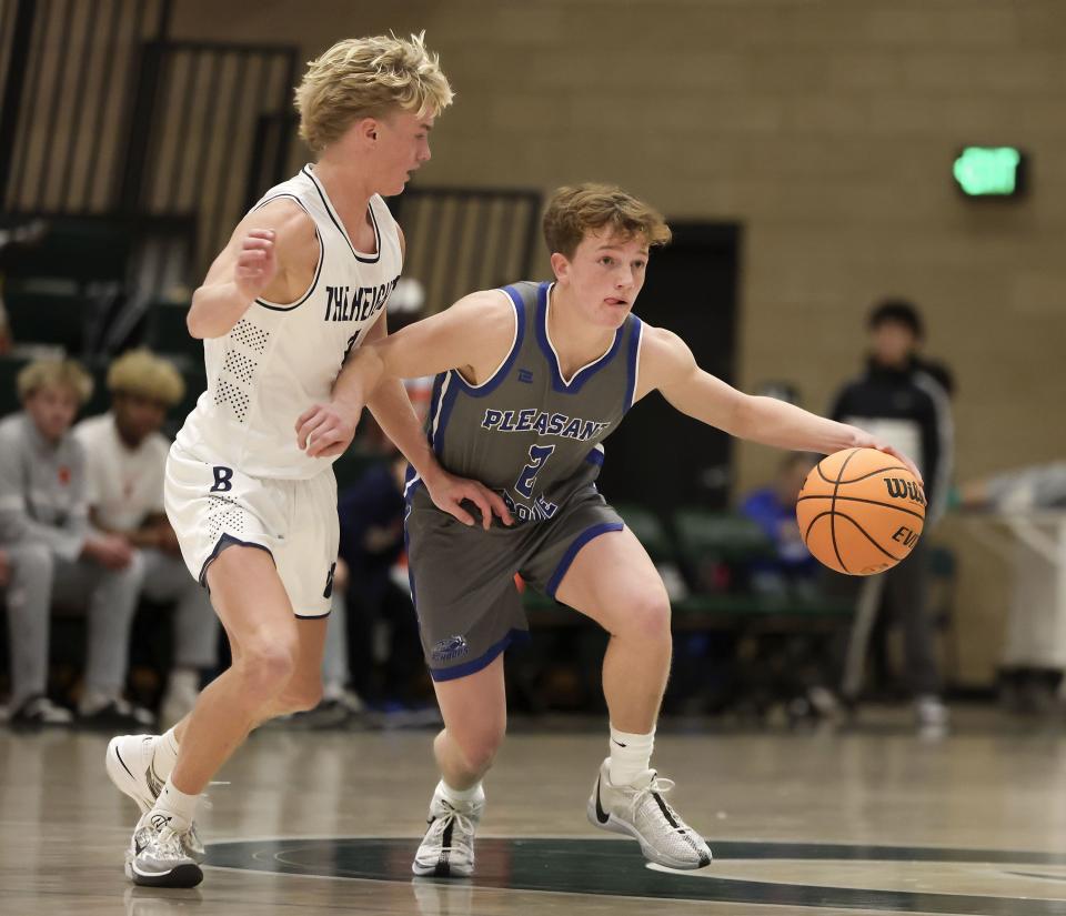 Pleasant Grove’s Carson Rasmussen drives past Brighton’s Case Beames in a neutral tournament game at Olympus High School in Holladay on Thursday, Dec. 28, 2023. | Laura Seitz, Deseret News