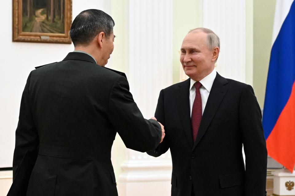 Russian President Vladimir Putin, right, shakes hands with China's Defense Minister Gen. Li Shangfu prior to the talks at the Kremlin in Moscow, Russia, Sunday, April 16, 2023. (Pavel Bednyakov, Sputnik, Kremlin Pool Photo via AP)