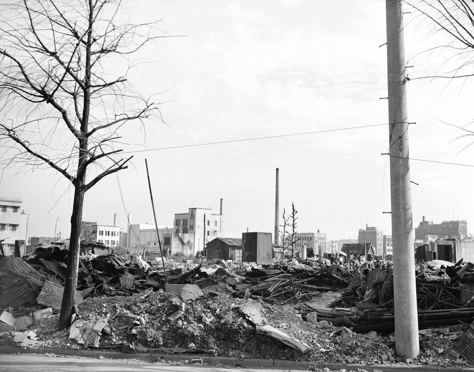 FILE - This Sept. 1, 1945, file photo shows destroyed business buildings in the city of Yokohama, near Tokyo. U.S. B-29's bombing raids left ruins debris and destruction near the American Consulate. The bombs stopped falling 75 years ago, but it is entirely possible - crucial even, some argue - to view the region’s world-beating economies, its massive cultural and political reach and its bitter trade, territory and history disputes all through a single prism: Japan’s aggression in the Pacific during World War II. (AP Photo/Frank Filan, Pool, File)