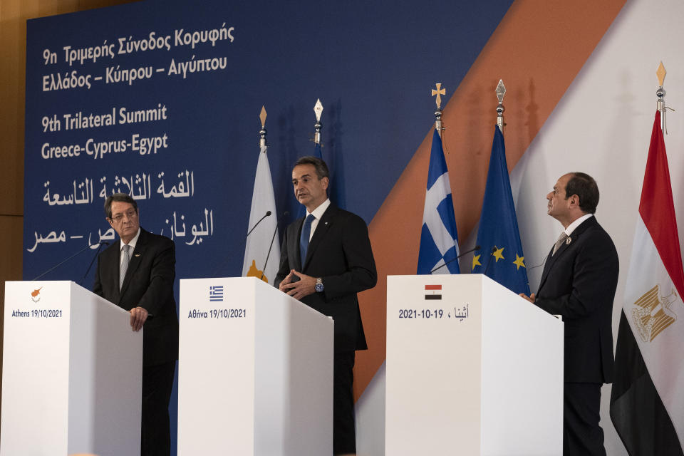 Greece's Prime Minister Kyriakos MItsotakis, center, Cyprus' President Nicos Anastasiades, left, and Egypt's President Abdel Fattah al-Sisi make statements following a meeting in Athens, Greece, Tuesday, Oct. 19, 2021. Athens hosts the 9th trilateral meeting between the three countries. (AP Photo/Yorgos Karahalis)