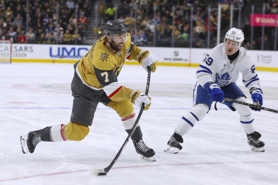 Vegas Golden Knights defenseman Alex Pietrangelo (7) shoots past Toronto Maple Leafs left wing Tyler Bertuzzi (59) during the second period of an NHL hockey game Thursday, Feb. 22, 2024, in Las Vegas. (AP Photo/Ian Maule)