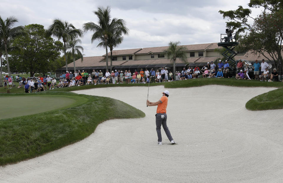 Rory McIlroy of Northern Ireland hits out of a bunker on the fifth hole during the first round of the Honda Classic golf tournament, Thursday, Feb. 27, 2014, in Palm Beach Gardens, Fla. (AP Photo/Lynne Sladky)