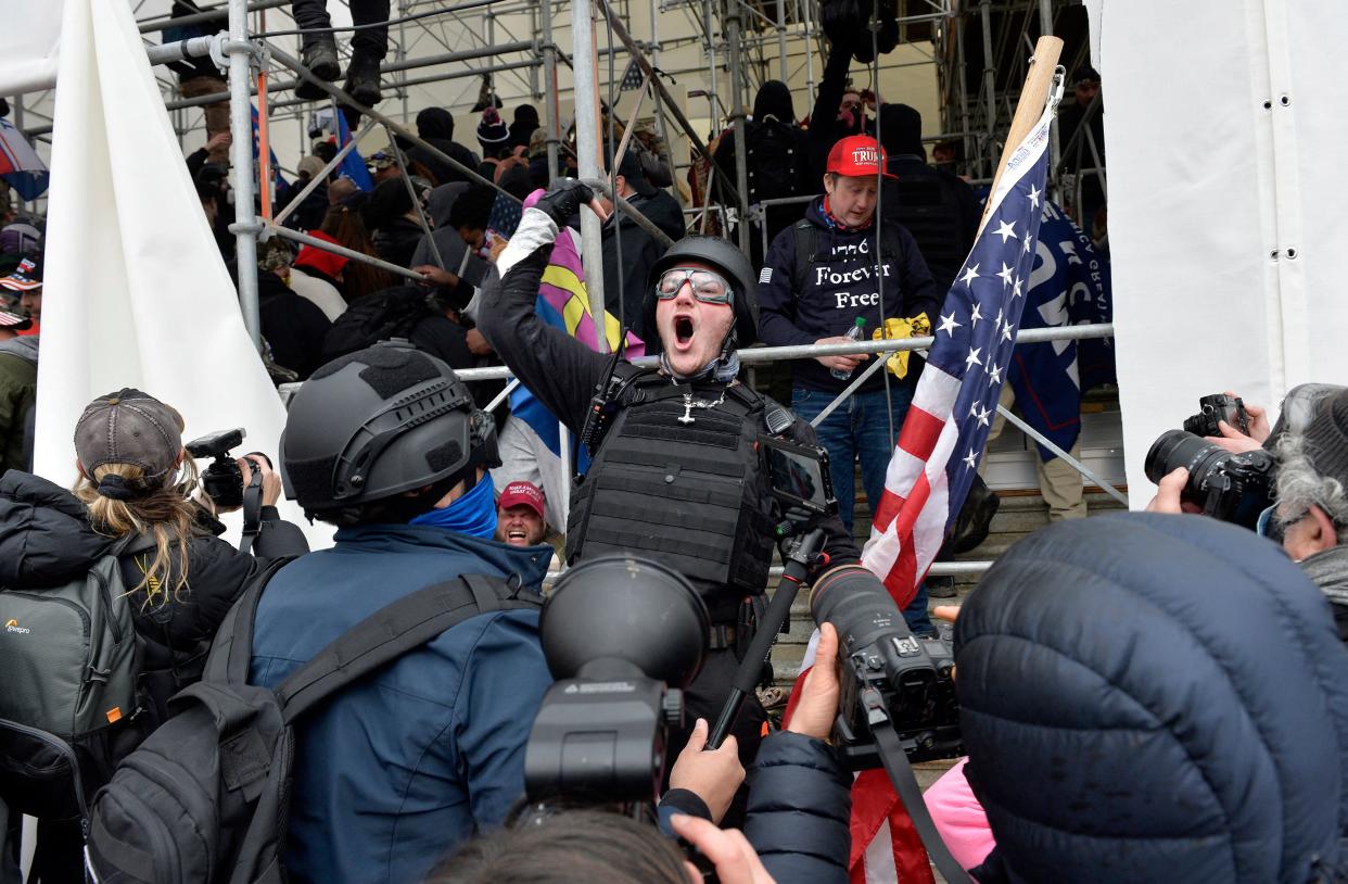 A man calls on people to raid the building as Trump supporters clash with police and security forces as they try to storm the US Capitol in Washington D.C on January 6, 2021. (Joseph Prezioso/AFP via Getty Images)