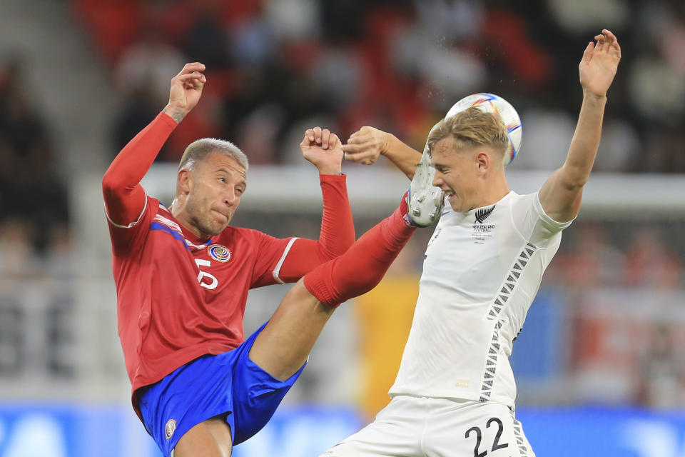 Costa Rica's Francisco Calva, left, and New Zealand's Ben Weine fight for the ball during the World Cup 2022 qualifying play-off soccer match between New Zealand and Costa Rica in Al Rayyan, Qatar, Tuesday, June 14, 2022. (AP Photo/Hussein Sayed)