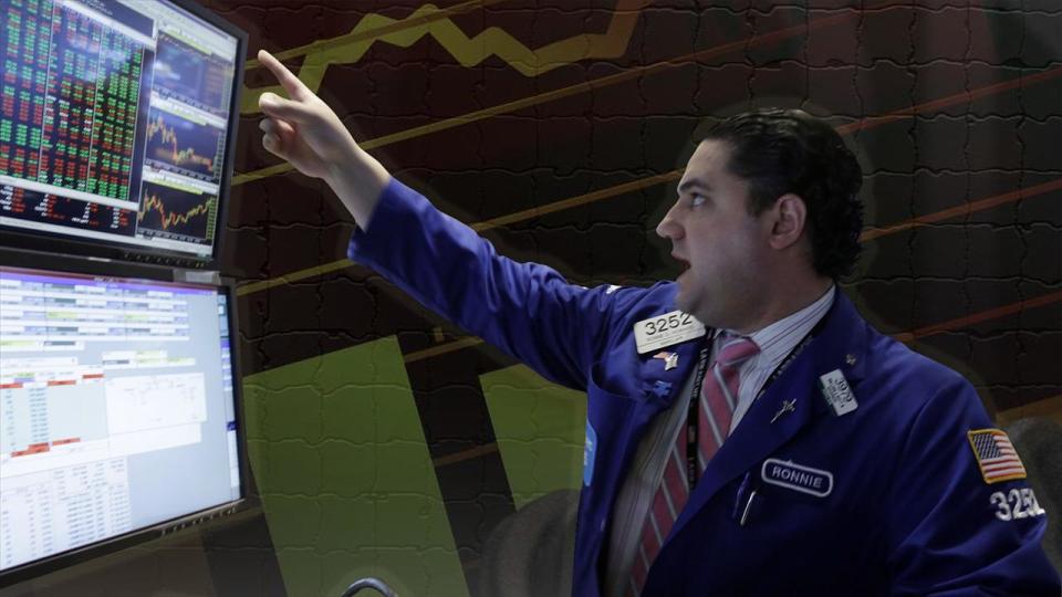 Specialist Ronnie Howard works at his computers on the floor of the New York Stock Exchange, New York City, on texture, partial graphic