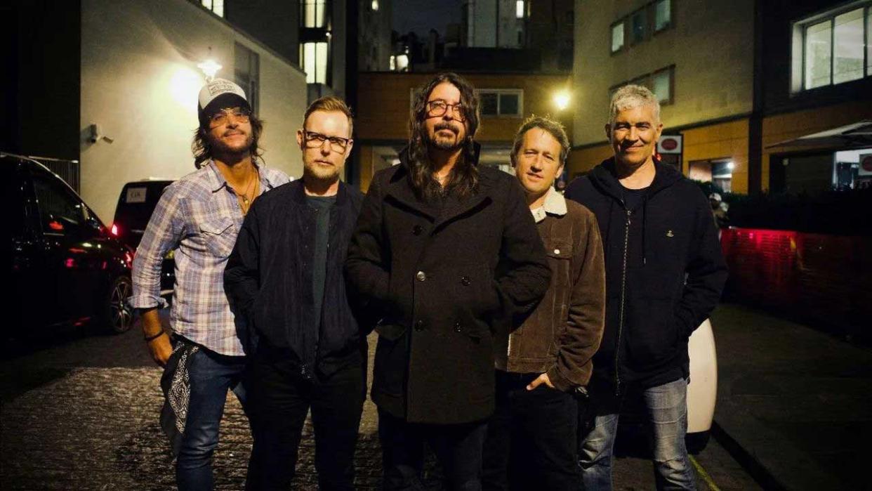  Foo Fighters standing together outside at night 