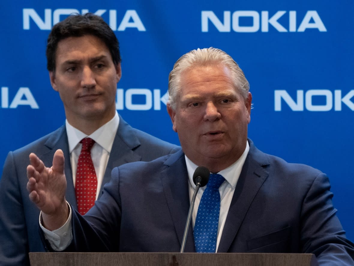 Ontario Premier Doug Ford answers a reporter's question as Prime Minister Justin Trudeau looks on at Nokia’s Canadian headquarters in Ottawa on Oct. 17, 2022. (Adrian Wyld/The Canadian Press - image credit)