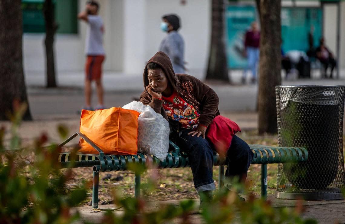 A homeless woman is seen by the Government Center in downtown Miami as many homeless people are refusing to be taken to a shelter by the City of Miami and The Homeless Trust, which are offering them a place to stay ahead of the chilly weekend, on Friday, Jan. 28, 2022.