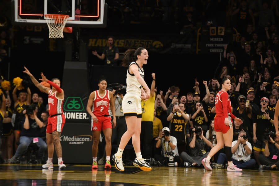 Iowa guard Caitlin Clark (22) celebrates after becoming the all-time leading scorer in NCAA Division I basketball during the first half of an NCAA college basketball game, Sunday, March 3, 2024, in Iowa City, Iowa. (AP Photo/Cliff Jette)