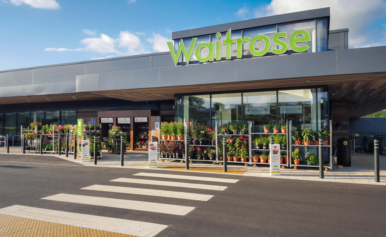 Glasgow, UK - July 19, 2015: The front entrance and facade of a Waitrose supermarket in Milngavie, Glasgow.