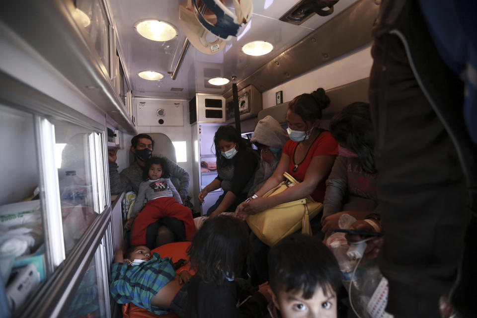 Migrants deported from the U.S. sit in an ambulance as they are driven to a shelter in Ciudad Juarez, Mexico, Tuesday, March 23, 2021. Mexico announced that U.S. advisers on border and immigration issues will meet with Mexican officials on Tuesday to discuss migration and development in Central America, as a surge of migrants has hit the U.S. southern border. (AP Photo/Christian Chavez)