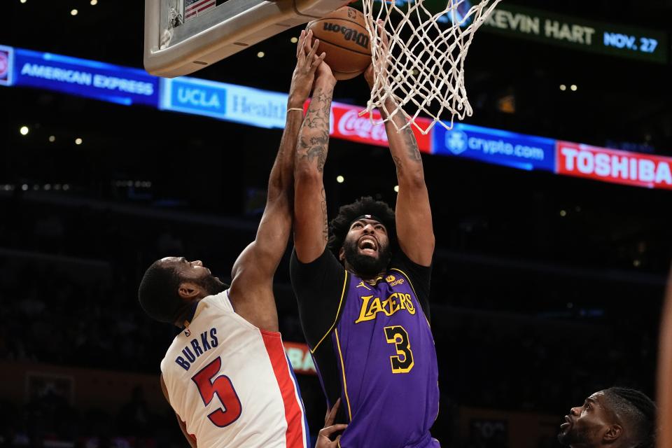 Los Angeles Lakers forward Anthony Davis, right shoots as Detroit Pistons guard Alec Burks defends during the first half of an NBA basketball game Friday, Nov. 18, 2022, in Los Angeles. (AP Photo/Mark J. Terrill)