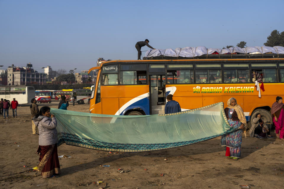 Indian pilgrims dry their sari, making sure it is ready for the journey ahead before departing from Pashupatinath temple in Kathmandu, Nepal, Jan. 9, 2024. The centuries-old temple is one of the most important pilgrimage sites in Asia for Hindus. Nepal and India are the world’s two Hindu-majority nations and share a strong religious affinity. Every year, millions of Nepalese and Indians visit Hindu shrines in both countries to pray for success and the well-being of their loved ones. (AP Photo/Niranjan Shrestha)