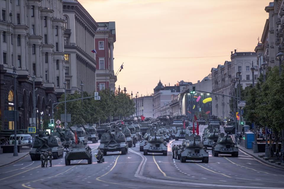 FILE - In this file photo taken on Thursday, June 18, 2020, Russian military vehicles prepare to roll along Tverskaya street toward Red Square during a rehearsal for the Victory Day military parade after sunset in Moscow, Russia. A massive military parade that was postponed by the coronavirus will roll through Red Square this week to celebrate the 75th anniversary of the end of World War II in Europe, even though Russia is continuing to register a steady rise in infections. (AP Photo/Alexander Zemlianichenko, File)