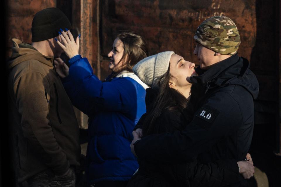 Ukrainian servicemen bid farewell to their partners at Kramatorsk train station in eastern Ukraine on January 3, 2023.