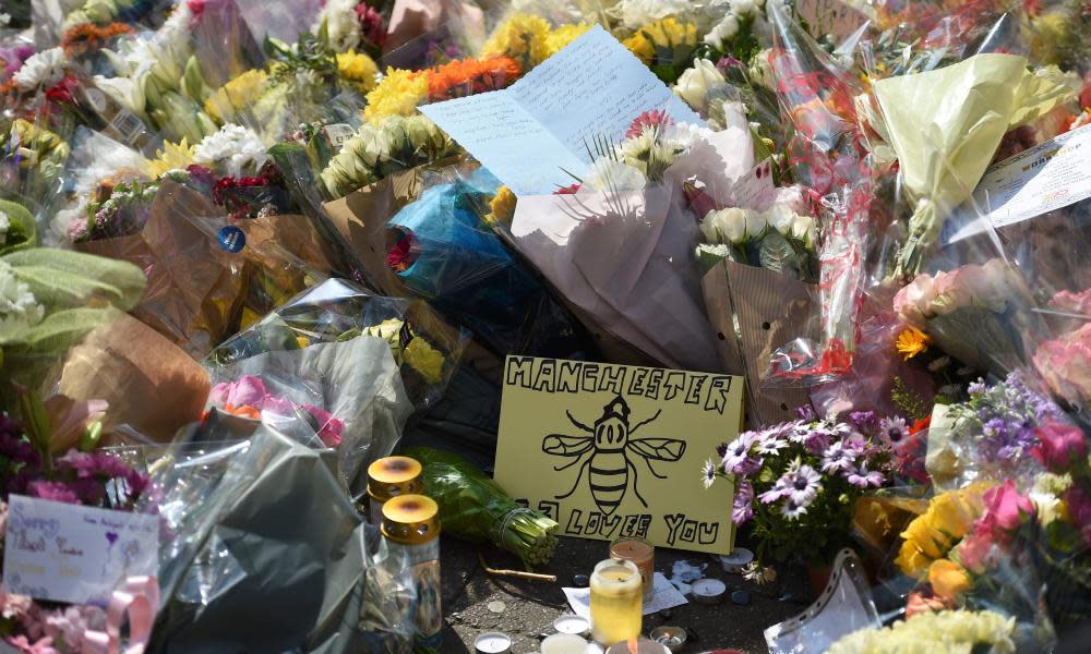 Flowers and messages of support are pictured in St Ann's Square in Manchester