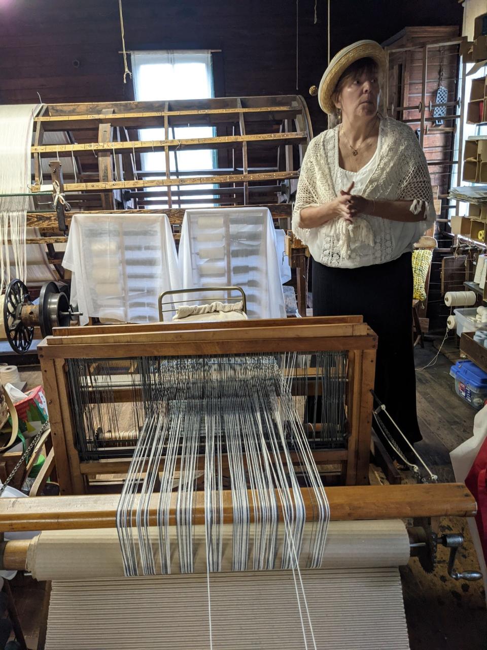 Heidi Breudigam, a volunteer at the Mishler Weaving Mill demonstrates the equipment seen on the tour.