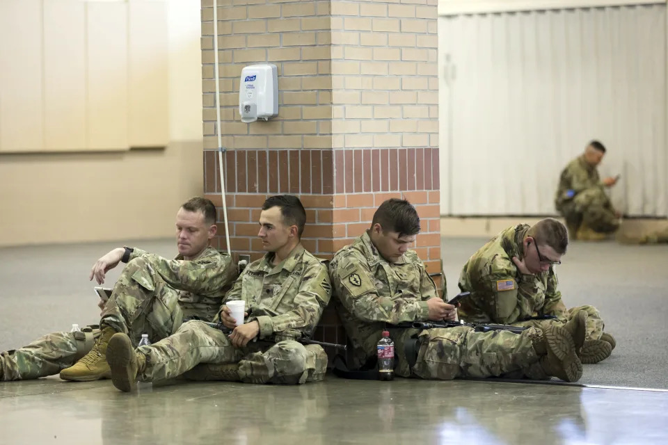 Soldiers with the U.S. Army 3rd Infantry Division, 1st Armored Brigade Combat Team wait before being deployed to Germany from Hunter Army Airfield, Wednesday March 2, 2022 in Savannah, Ga. The division is sending 3,800 troops as reinforcements for various NATO allies in Eastern Europe. (Stephen B. Morton /Atlanta Journal-Constitution via AP)