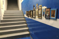 Saints icons are displayed on a wall before the stairway leading the field entrance of the San Paolo's stadium in Naples, Italy Tuesday, Sept. 17, 2019. Before he climbed the steps and emerged before the crowd, Maradona used to pray to the Madonna di Pompei and kiss the prayer card. (AP Photo/Andrew Dampf)