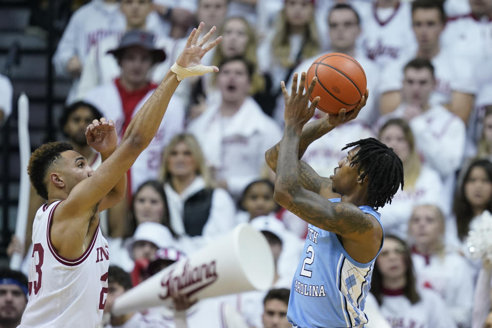 North Carolina's Caleb Love (2) shoots over Indiana's Trayce Jackson-Davis (23) during the second half of an NCAA college basketball game, Wednesday, Nov. 30, 2022, in Bloomington, Ind. (AP Photo/Darron Cummings)