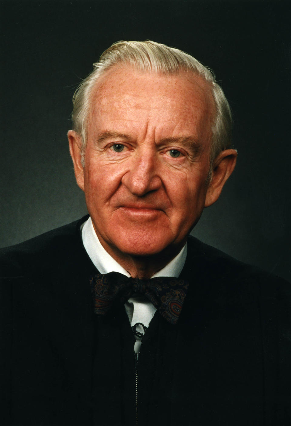 An official portrait of Justice John Paul Stevens in his judicial&nbsp;robes and trademark bowtie.