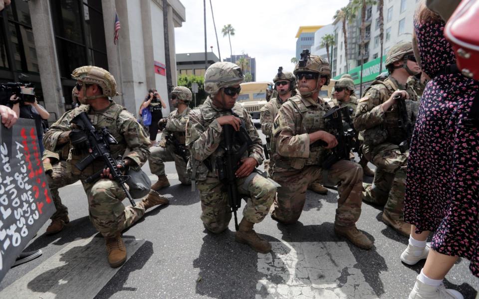 Members of the National Guard take a knee in Hollywood as people protest the death of George Floyd - DAVID SWANSON/EPA-EFE/Shutterstock/Shutterstock