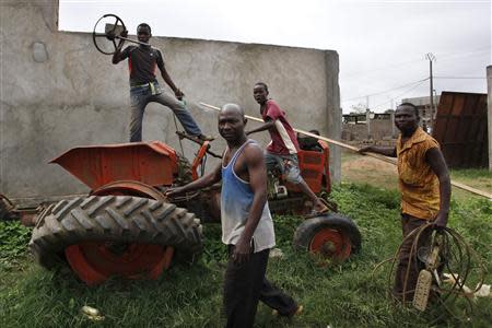 Christians remove parts from a tractor at a mosque compound in Bangui