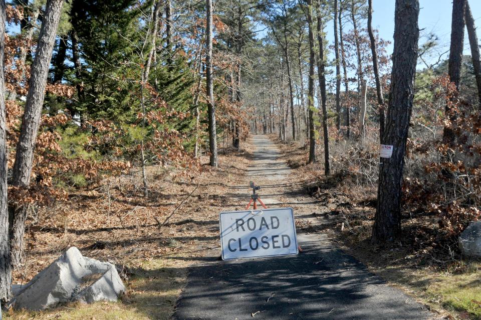 A "road closed" sign on Monday warns bicyclists at the end of the Cape Cod Rail Trail off Higgins Crowell Road in West Yarmouth. Paul Graves, senior project manager for the town of Barnstable Department of Public Works, said the rail trail project for a roughly four-mile section from Yarmouth west to Mary Dunn Road in Barnstable has been in development for years and construction bids will be going out in August.