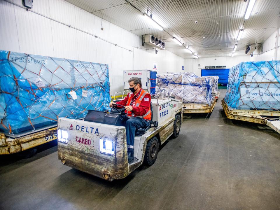 A worker moving cargo around warehouse.