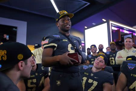 Dec 22, 2018; Ft. Worth, TX, United States; Army Black Knights quarterback and MVP Kelvin Hopkins Jr. (8) speaks to his teammates in the locker room after defeating Houston 70-14 to win the Armed Forces Bowl at Amon G. Carter Stadium. Mandatory Credit: Danny Wild-USA TODAY Sports