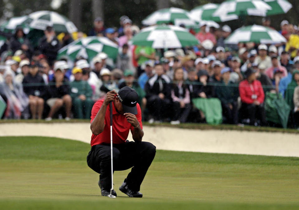 <p>Tiger Woods waits to putt on the 18th green during the fourth round of the Masters golf tournament Sunday, April 14, 2013, in Augusta, Ga. (AP Photo/David J. Phillip) </p>