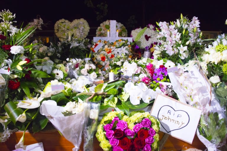 Flowers adorn the tomb of French rock icon Johnny Hallyday in the Lorient cemetery on the French Caribbean island of St Barts on December 11, 2017