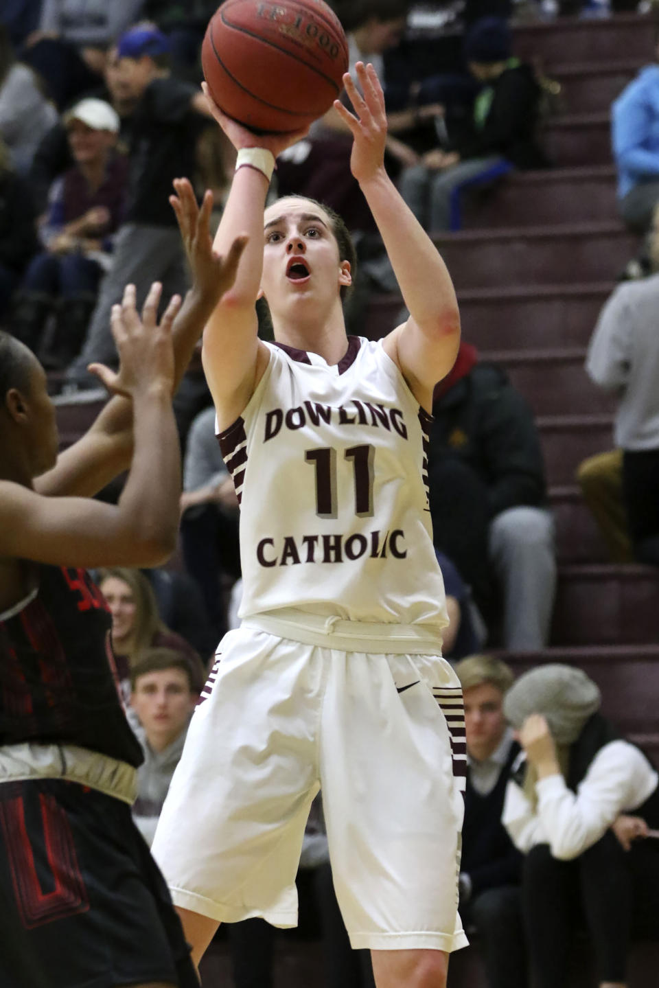 In this photo provided by Dowling Catholic High School, high school guard Caitlin Clark shoots during a girls basketball game, Jan. 16, 2018, in West Des Moines, Iowa. Clark's skills were so advanced when she was in grade school that her parents signed her up to play on boys teams, and by the time she entered middle school she was well-known in basketball circles across Iowa. This was long before Clark, now at the University of Iowa, became one of the faces of women's basketball and, now, on the cusp of setting the Division I scoring record. (AP Photo/Earl Hulst via AP)