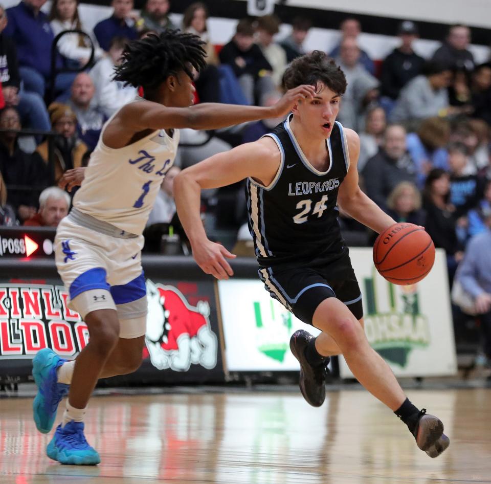 Louisville guard Hayden Nigro drives to the basket against Lutheran East guard Chris Hill during the first half at Canton Memorial Field House, Saturday, Feb. 17, 2024.