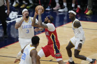 New Orleans Pelicans forward Brandon Ingram (14) goes to the basket between Los Angeles Lakers forward Anthony Davis (3), forward Rui Hachimura (28) and guard Dennis Schroder in the second half of an NBA basketball game in New Orleans, Saturday, Feb. 4, 2023. The Pelicans won 121-136. (AP Photo/Gerald Herbert)