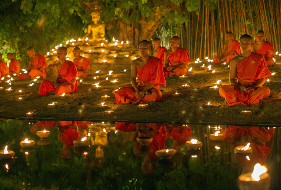 <p>Thai Buddhist monks meditate with candle lighting during the religious ceremony to mark Vesak Day or Visakha Bucha at Wat Pan Tao in Chiang Mai province, northern Thailand, May 20, 2016. Vesak Day or Visakha Bucha, one of the holiest days in Buddhism to commemorating the birth, enlightenment and the death of Buddha. (PONGMANAT TASIRI/EPA) </p>