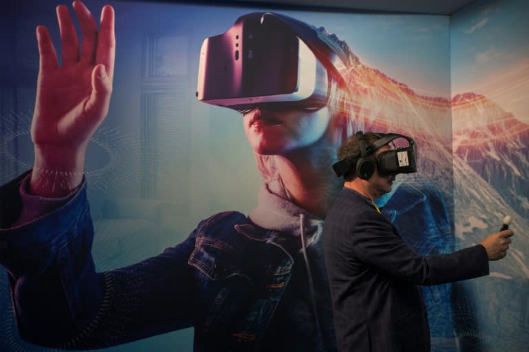 A man wearing a VR headset experiments with a merged reality experience using Project Alloy at the Intel exhibit during the 2017 Consumer Electronic Show in Las Vegas