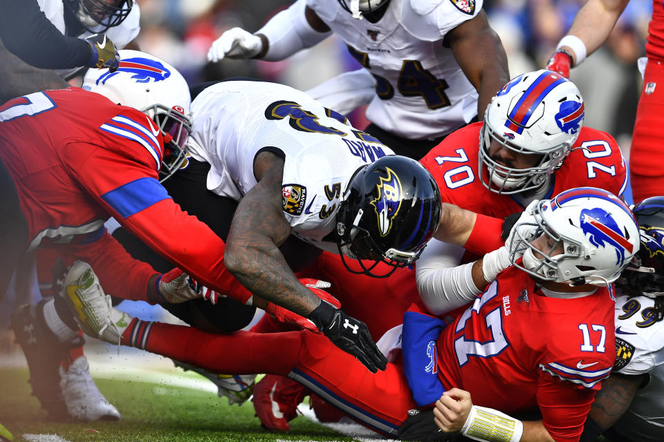 Buffalo Bills quarterback Josh Allen (17) has the ball knocked loose as he is hit by Baltimore Ravens outside linebacker Matt Judon (99), right, during the first half of an NFL football game in Orchard Park, N.Y., Sunday, Dec. 8, 2019. The fumble was recovered by Ravens defensive end Jihad Ward (53). (AP Photo/Adrian Kraus)