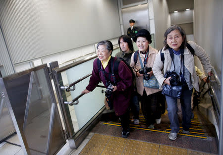 Royal aficionado Fumiko Shirataki, 78, and her friends rush to secure their photo position before arrival of Japan's Crown Prince Naruhito, Crown Princess Masako and their daughter Princess Aiko, at Tokyo Station in Tokyo, Japan, March 25, 2019. REUTERS/Issei Kato