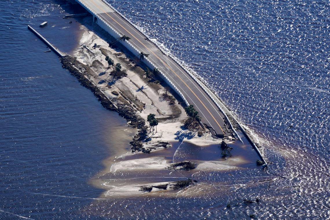 In this aerial photo made in a flight provided by mediccorps.org, damage from Hurricane Ian is seen on the causeway leading to Sanibel Island from Fort Myers, Fla., Friday, Sept. 30, 2022. (AP Photo/Gerald Herbert)