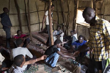 Senegalese and Guinean migrants gather in a welcome center, which is for migrants deported from Libya or those who wish to go home and managed by the Red Cross and the International Organization for Migration (IOM), in Agadez March 16, 2014. REUTERS/Joe Penney